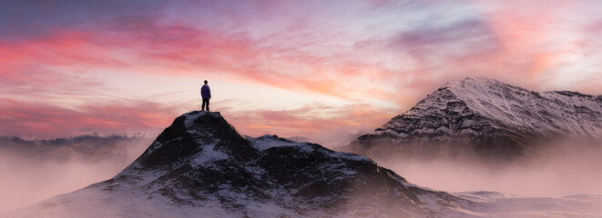Adventurous Man Hiker standing on top of icy peak with rocky mountains. Adventure Composite. 3d Rendering rocks. Aerial Background Image of landscape from Canada. Sunset Sky