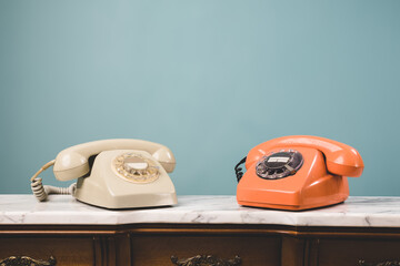 View of two old telephones on a table.