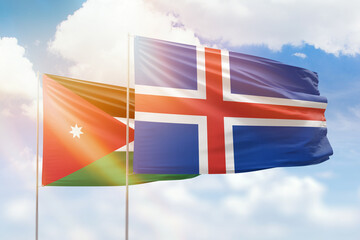 Sunny blue sky and flags of iceland and jordan