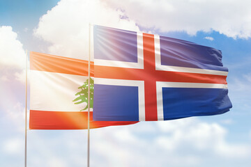 Sunny blue sky and flags of iceland and lebanon