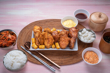 Wall Mural - Korean style crispy fried chicken with dipping cheese and rice cakes.