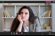 © golubovy - Online education. Boring woman. Screen mockup. Careless lady sitting desk enhancing chin on hand having webinar in light room interior.