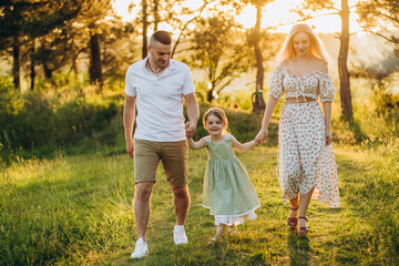 Wall Mural - Happy family resting in summer park.Cheerful family picnicking in the park.Summertime and vacation concept.