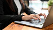 © bongkarn - Close-up image, Female office worker working on laptop computer, typing on keyboard