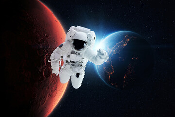 Wall Mural - beautiful astronaut flies in zero gravity on a background of the blue planet earth with the rays of 