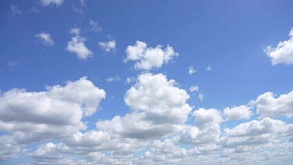 Wall Mural - 4k video time lapse of beautiful sunny cloudy sky. white fluffy clouds flying in clear sky slowly. n