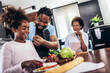 © Mediteraneo - Happy multigenerational african american family make dinner together.