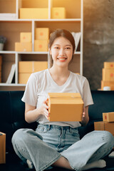 Wall Mural - Asian woman working in modern warehouse and delivery service via modern technology