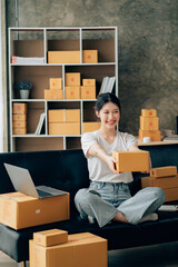 Wall Mural - Asian woman working in modern warehouse and delivery service via modern technology