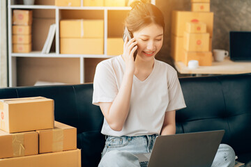 Wall Mural - Asian woman working in modern warehouse and delivery service via modern technology