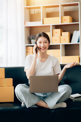 Wall Mural - Asian woman working in modern warehouse and delivery service via modern technology