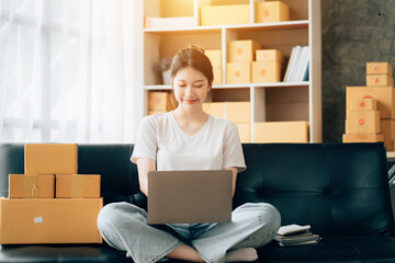 Wall Mural - Asian woman working in modern warehouse and delivery service via modern technology