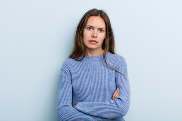 Wall Mural - young adult pretty woman feeling displeased and disappointed, looking serious, annoyed and angry with crossed arms