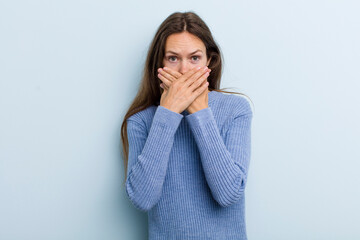 Wall Mural - young adult pretty woman covering mouth with hands with a shocked, surprised expression, keeping a secret or saying oops