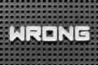 © bankrx - White alphabet letter in word wrong on black pegboard background