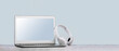 Laptop. Mockup screen and wireless headphones on white desk. plain blue background. Distant learning. working from home, online courses. minimal. Helpdesk support or call center headset