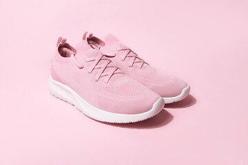 Pink pastel color sneakers on background