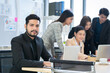 © SKW - Asian businessman looking at the camera Working and meeting at the office at the company with colleagues at the back