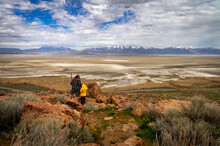 Father And Son Hiking On Rocks At Antelope Island In Utah