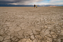 Father And Son Walking In A Dry Lake Bed In Antelope Island Utah