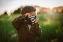 Hipster Little Boy With Vintage Camera Outdoors. Child In Costume