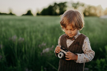 Hipster Little Boy With Vintage Camera Outdoors. Child In Costume