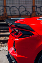 Canvas Print - Rear of a red sports car with a carbon fiber spoiler