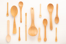 Set Of Empty Wooden Spoons Of Different Sizes With Over White Background, Trendy Flat Lay