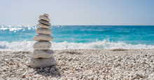 Stacked Stones On A Beautiful White Pebble Beach In The Mediterranean