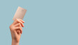 Leinwandbild Motiv Banner with hand holding credit card mockup with chip on blue background. Buying at stores, making transactions at terminals. Secure payments. High quality photo