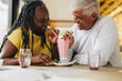© Jacob Lund - Happy mature couple sharing a delicious milkshake in a cafe