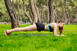 © platinumArt - Side view of brunette woman wearing sports bra standing on city park, outdoors doing plank exercise on yoga mat. Healthy lifestyle, workout, training, endurance concept.