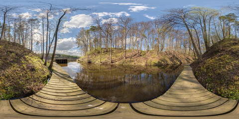 Wall Mural - full seamless spherical hdri 360 panorama view on wooden pier of lake or river among forest with beautiful clouds in equirectangular projection, VR content