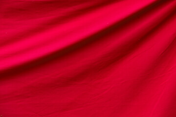 Red fabric with folds as texture or background, large backdrop