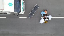 Top View Emergency Team Use Stretcher Cot To Transport Or Move Patient Into Ambulance After He Hurt By Some Accident On Road.