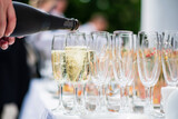 Fototapeta Kawa jest smaczna - Waiter pouring champagne into glass