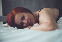 Sensual Woman In Her Bed At Dawn, Between The Sheets Of Her Bedroom At Home