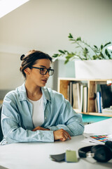 Wall Mural - Young woman digital designer working on tablet and computer