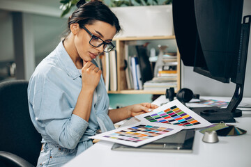 Wall Mural - Young woman digital designer working on tablet and computer