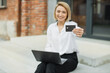 © sofiko14 - Focus on bank credit card. Business payment of bills concept. Smiling young woman, using notebook and holding credit card for making payments online. Female freelancer receive payment online.