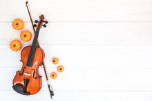 Violin, Bow And Pumkin On White Wood Background. Autumn Flatlay Wit Copyspace