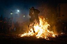 Horses With Their Riders Jumping Bonfires As A Tradition To Purify Animals..