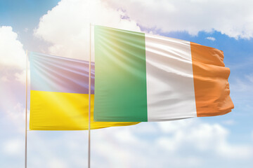 Wall Mural - Sunny blue sky and flags of ireland and ukraine