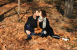  Beautiful young couple in the autumn park with falling foliage. 