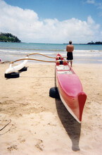 Hawaiian Outrigger Canoe With A Single Paddler Watching The Ocean