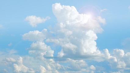 Wall Mural - clouds and sunshine. white clouds and sun rays in a light blue sky.beautiful heavenly wallpaper in b