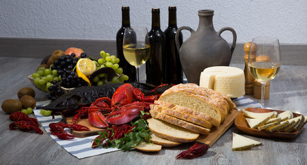 Still life with tasty seafood, wine, cheese and bread on table