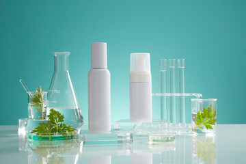 front view of transparent podium with laboratory equipment and mugwort in blue background science co