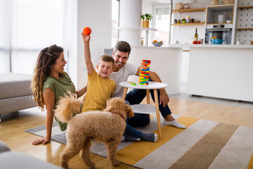 Happy family having fun, playing board game at home