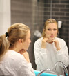 © lado2016 - woman looking in the mirror in the bathroom and taking care of her skin.Applying the cream..Magic anti-aging cream.
